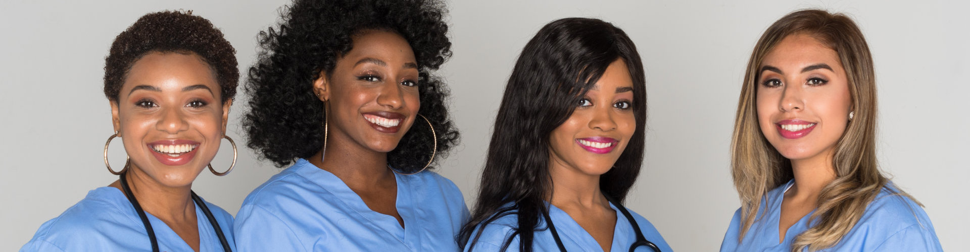 four nurses smiling